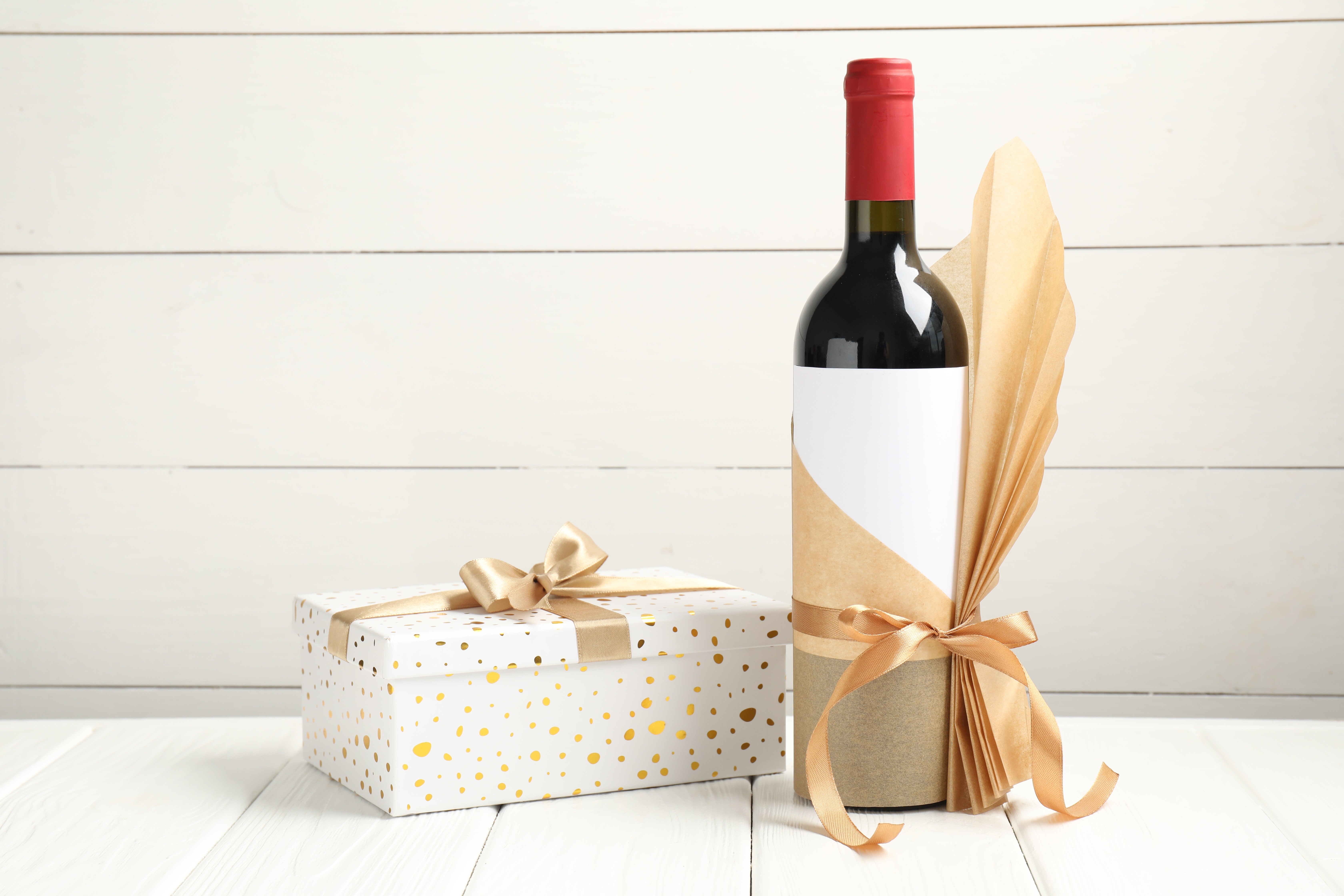 festive-wine-bottle-and-polka-dot-gift-box-on-whit-2026-07-24-22-41-54-utc